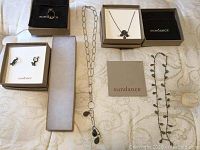 Overview of four Sundance jewelry pieces on fabric background