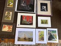 Overview of ten matted prints arranged on floor