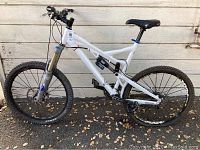 Side view of white Intense Spider full suspension mountain bike showing frame, wheels and saddle