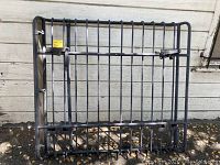 Front view of steel tubular grid basket leaning against wall