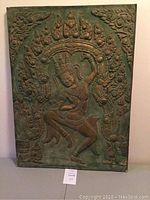 Front view of the vintage bas-relief panel showing a dancing figure with ornamental surroundings.