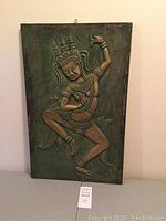 Full view of the rectangular metal bas-relief wall plaque showing Thai dancer with hanging hook on the top center.