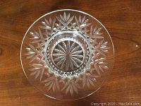 Top-down view showing starburst and leaf cut crystal pattern inside the shallow container