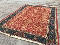 Full view of the rectangular rug laid on pavement