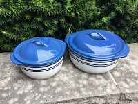 Two blue-lidded Corelle casserole dishes placed side by side showing lids and base design