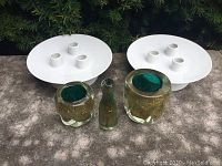 Two white porcelain Rosenthal pedestal holders for three candles, and three gold leaf embedded glass vessels including one with stopper.