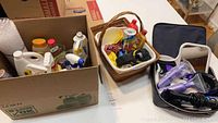 Overview image showing box with cleaning products, basket with additional cleaning agents, and hair care items including a hair straightener in black case with hair coloring kits.