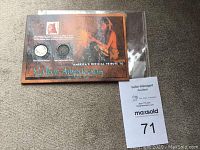 Collector coin set with 1893 Indian Head penny and 1937 Buffalo nickel inside a Native Americans tribute display case on carpet surface.