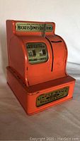 Front angle showing detailed labels and coin slot on the vintage toy cash register bank.