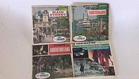 Three Disneyland themed View-Master reel packages featuring Main Street USA, Frontierland, and Adventureland on a flat surface.