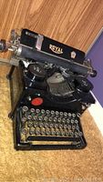Front-left perspective of entire typewriter on table.