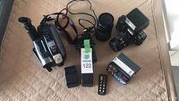 Overview of all camera equipment and accessories included in the lot