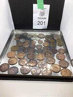 Overview tray of 45 old British coins of different denominations and sizes, from copper to silver tone, arranged on a metal tray.