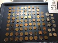 Tray filled with various older Canadian coins. The coins display signs of wear and aging, arranged in rows showing different sizes and metal colors.