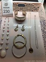 All seven jewelry items arranged on tray