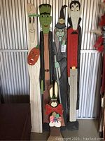 Full view of all five vintage wooden seasonal figures side by side, showing style and size