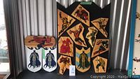 All four wooden superhero-themed wall plaques arranged closely together, showing the size and style of each plaque.