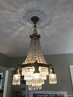 Overall view of chandelier hanging from ceiling