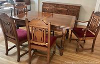 Dining table set with sideboard in background