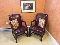 Front view of both armchairs with framed swan boats photo above