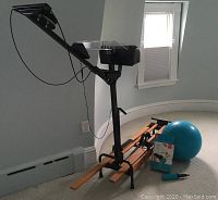 Full view of the NordicTrack cross-country ski machine next to the blue Pilates ball and pump