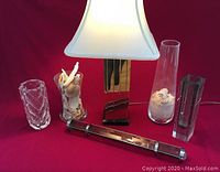 Full view of modern lamp, vases, and kaleidoscope on red background