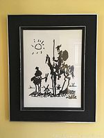 Frontal view of framed black and white Picasso print featuring Don Quixote and Sancho Panza figures.