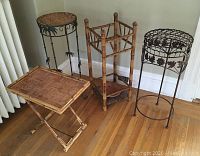 Photo of all four items: three stands (two metal, one bamboo) and one folding bamboo tray table.
