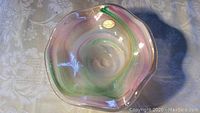 Top view of the Murano glass bowl showing pastel swirled colors and wavy edge.