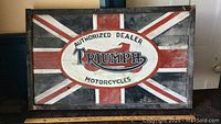 Full view of the wooden sign showing the Union Jack background and the Triumph Authorized Dealer logo