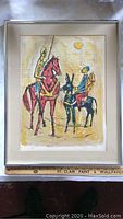 Framed art print featuring two riders on animals with a sun overhead