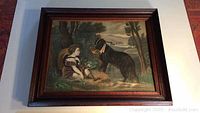 Full view of framed art print showing boy, dog, basket, tree, lake, and mountains.