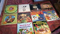 Photo showing a collection of 10 children's music LP covers including Looney Tunes, Snoopy, Sesame Street, Muppets, Winnie the Pooh, Tweety Pie, Woody Woodpecker, Smurfs, and Uncle Remus titles.