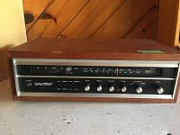 Front view of the vintage AGS solid state tuner receiver showing control knobs and tuning display with wood casing.
