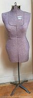 Full front view of purple and white dress form on cast iron tripod base