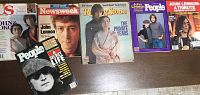 Six magazines laid out on table, all with John Lennon covers, varying publication titles and colors.