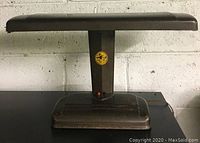 Full view of the vintage desk lamp showing its rectangular shade, metal body, and base.