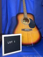 Overall front view of Eleca acoustic guitar showings sunburst finish and general condition.