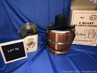 Wide shot showing both Sunbeam popcorn maker and RCW ice cream freezer with original box on blue fabric background