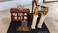 Overall arrangement of all miniatures: hutch, porcelain tea set, harp, pedestals with urns and fireplace accessories