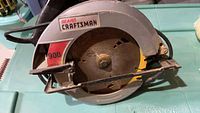 Photo showing side view of the Sears Craftsman 900 circular saw with blade guard, blade, and power cord visible.