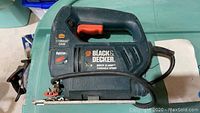 Black & Decker Quick Clamp variable speed jigsaw showing front and side view, including branding and quick clamp mechanism.