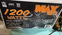 Box showing Lanzar MaxST branding and product specifications including 1200 watts peak power and 15-inch size