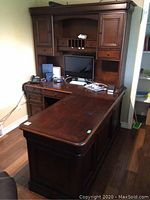 Front left perspective of complete L-shaped desk and hutch in room