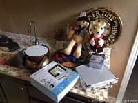 Photo showing poker tray, ice bucket, wine tool kit, plush bear and fox toys, remote pet training collar box, and poker tray clock in background.