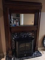 Full frontal view of oak mantel, mirror, marble hearth and electric insert