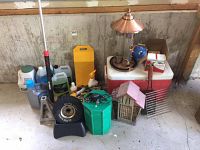 Overview of garage lot with multiple items including car fluids, tire block, bird feeders, cooler, and more.
