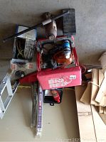 Top view of car items including polisher, hoses, wiring, and spray cans.