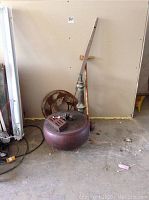 Wide view of lot showing Tibetan horn, copper pot, wood poker, carved cane, iron wheel, skeleton keys and door hinge