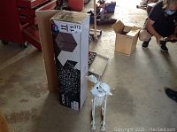 Full view of the Noma Blossom Tree box and the metal garden dog sculpture on the floor.